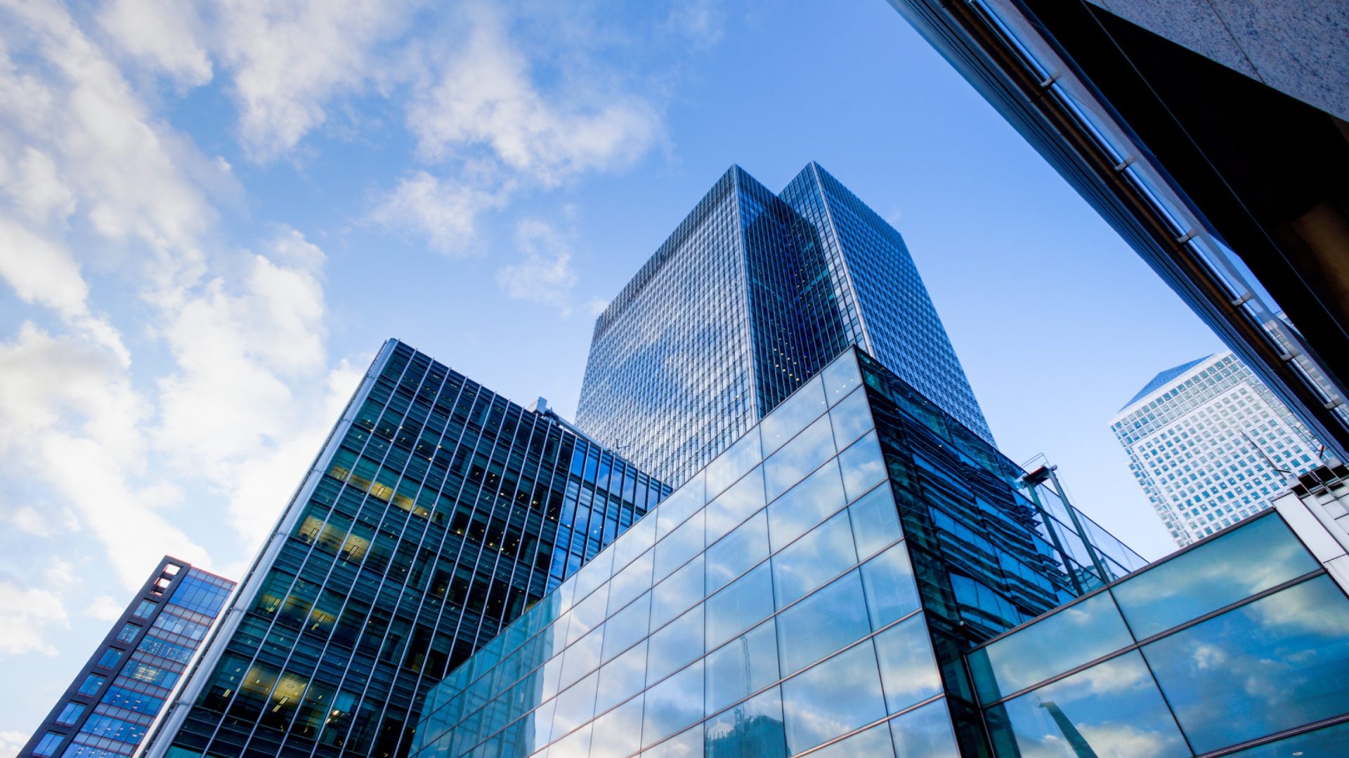 Two modern buildings with glass windows. Architecture design of buildings. Office space, houses at sunset in the evening. 3D render.